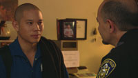 Police officer talks with Sann